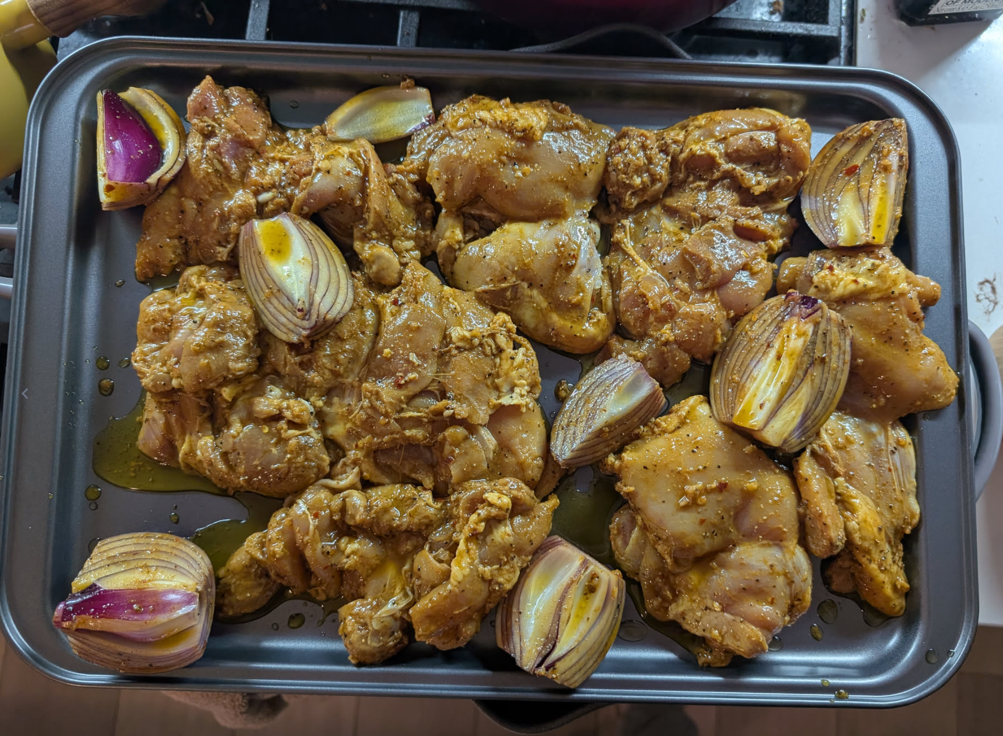 marinated chicken, laying on a pan